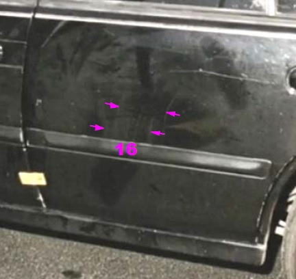 View of Nissan Maxima left rear door showing width indicators of assault weapon roughly estimated at 8 to 10 inches.